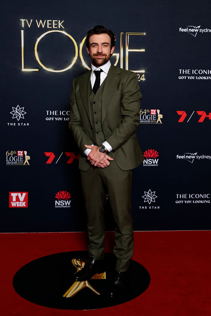 The Olive Horizon Suit worn by a model on a red carpet, front view