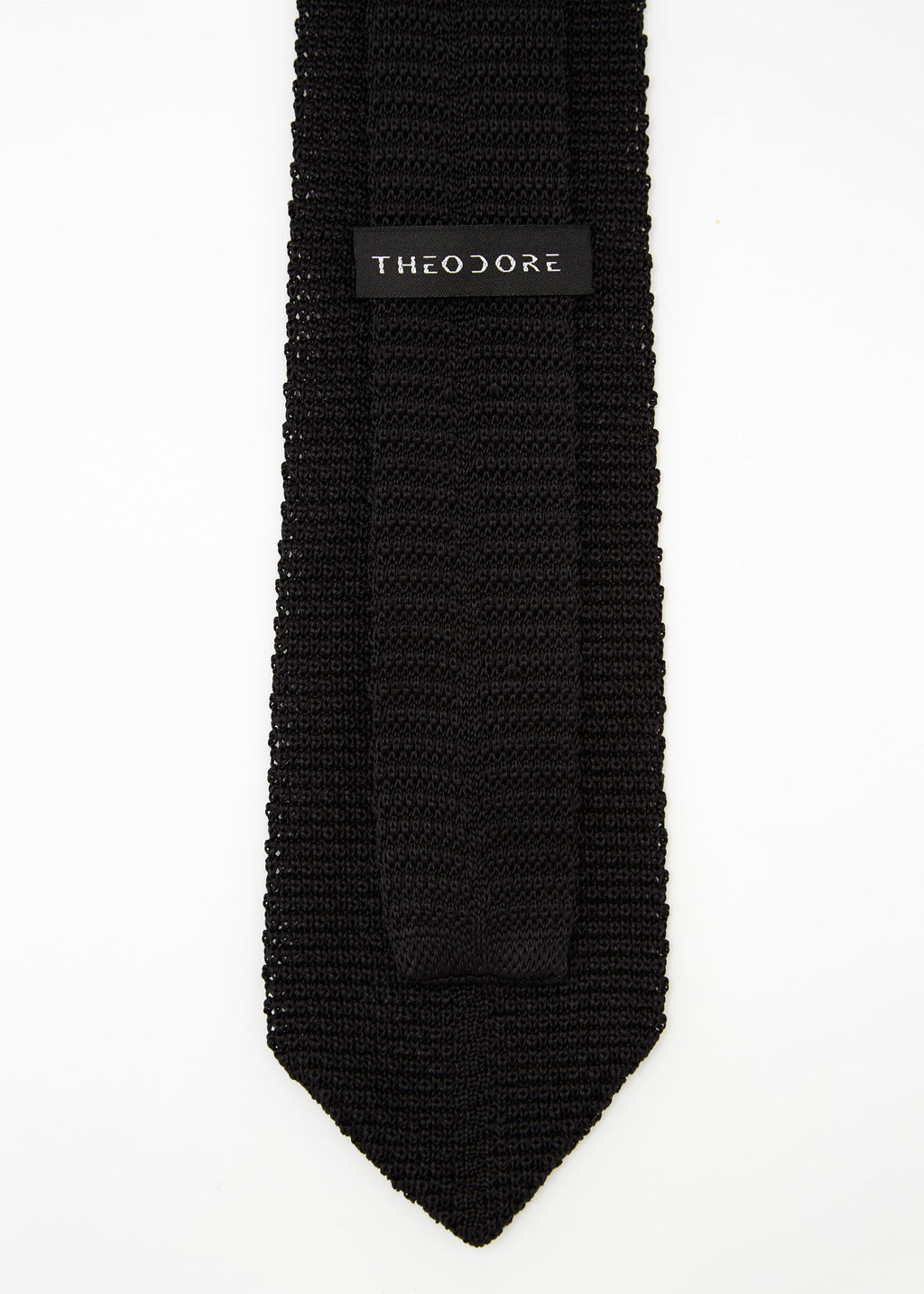 Hong Kong Tie in knit black silk, close-up of the Theodore label on the keeper loop