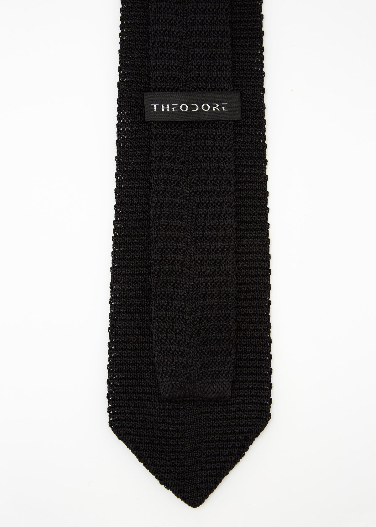 Hong Kong Tie in knit black silk, close-up of the Theodore label on the keeper loop