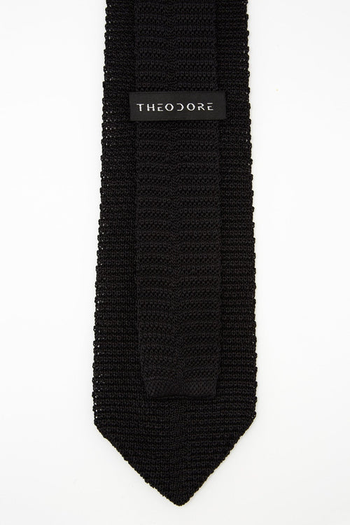 Hong Kong Tie in knit black silk, close-up of the Theodore label on the keeper loop