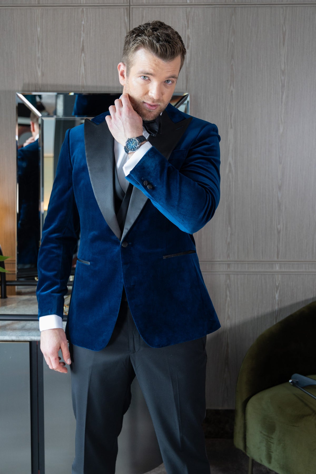 Close-up of a model in the Velvet Noir tuxedo, hand near the collar