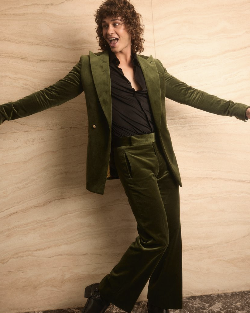 Retro Emerald Velvet Tuxedo worn by a model in a playful, dynamic pose