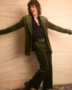 Retro Emerald Velvet Tuxedo worn by a model in a playful, dynamic pose