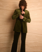 Retro Emerald Velvet Tuxedo worn by a model adjusting the sleeve cuff