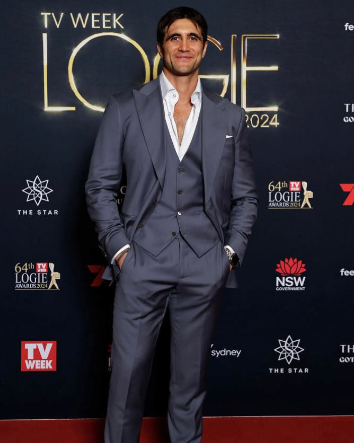 The Vivid Voltage Steal Grey Suit worn by a model on a red carpet