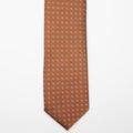 Seoul Tie in brown dotted pattern, flat lay on a plain background