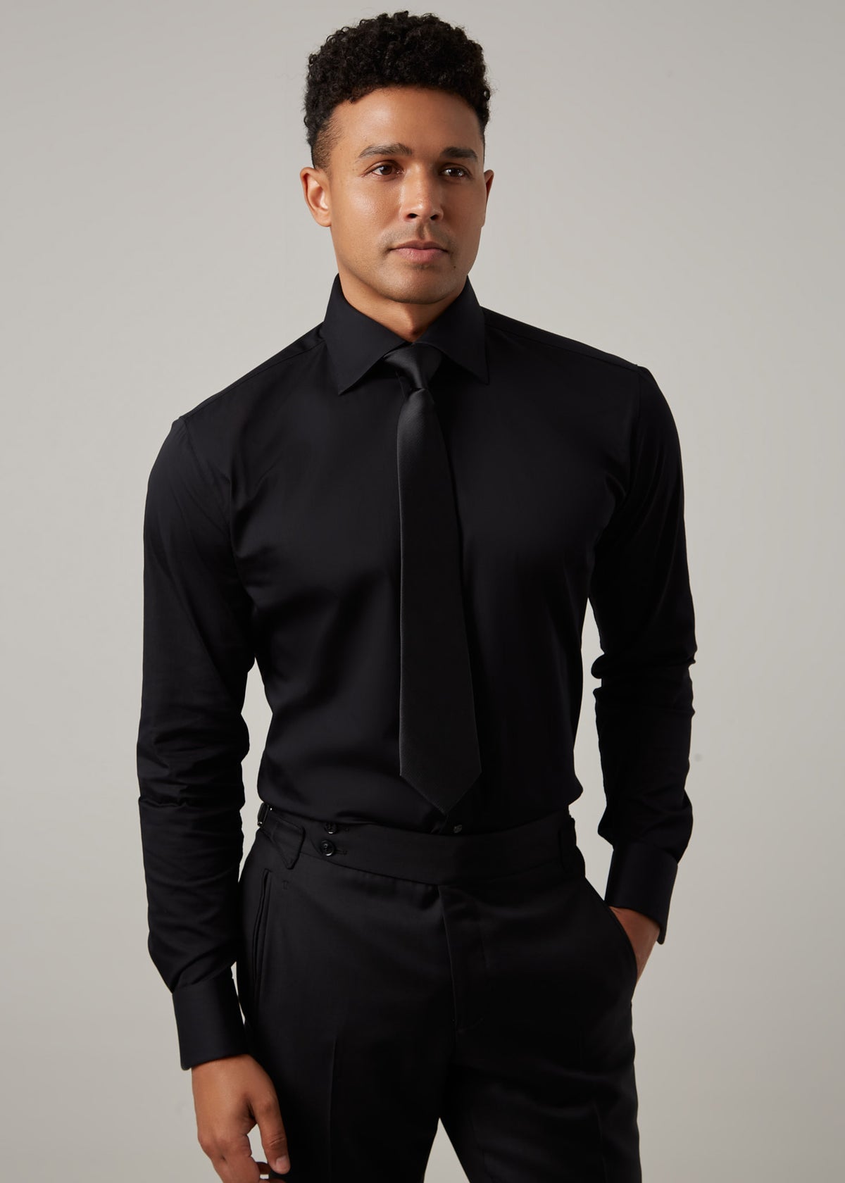 Our Perfect Black Shirt worn with a black tie, front view on a model