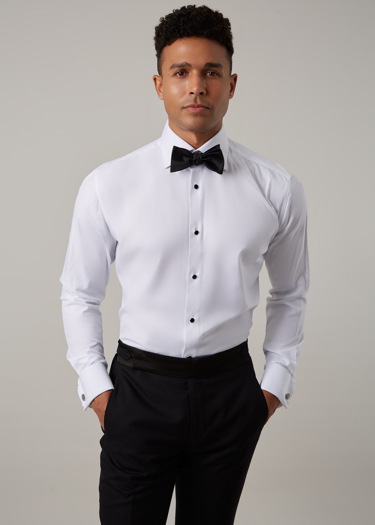 Close-up of the Glamorous Tuxedo Shirt front studs and bow tie on a model