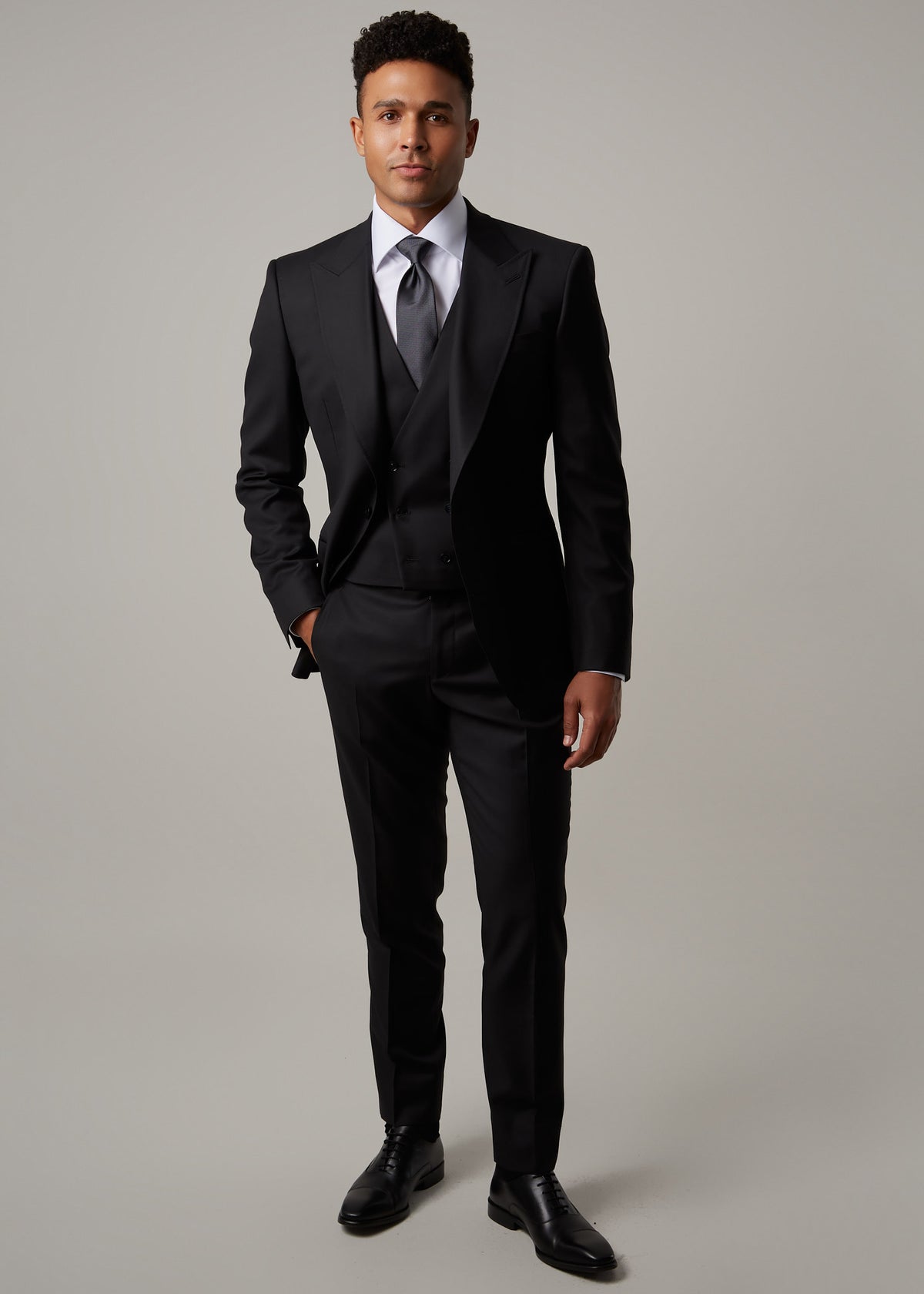 Midnight Milano The Ultimate Black Suit and waistcoat worn full-length, adjusting the sleeve