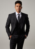 Midnight Milano The Ultimate Black Suit waistcoat, close-up with hands adjusting the cuff
