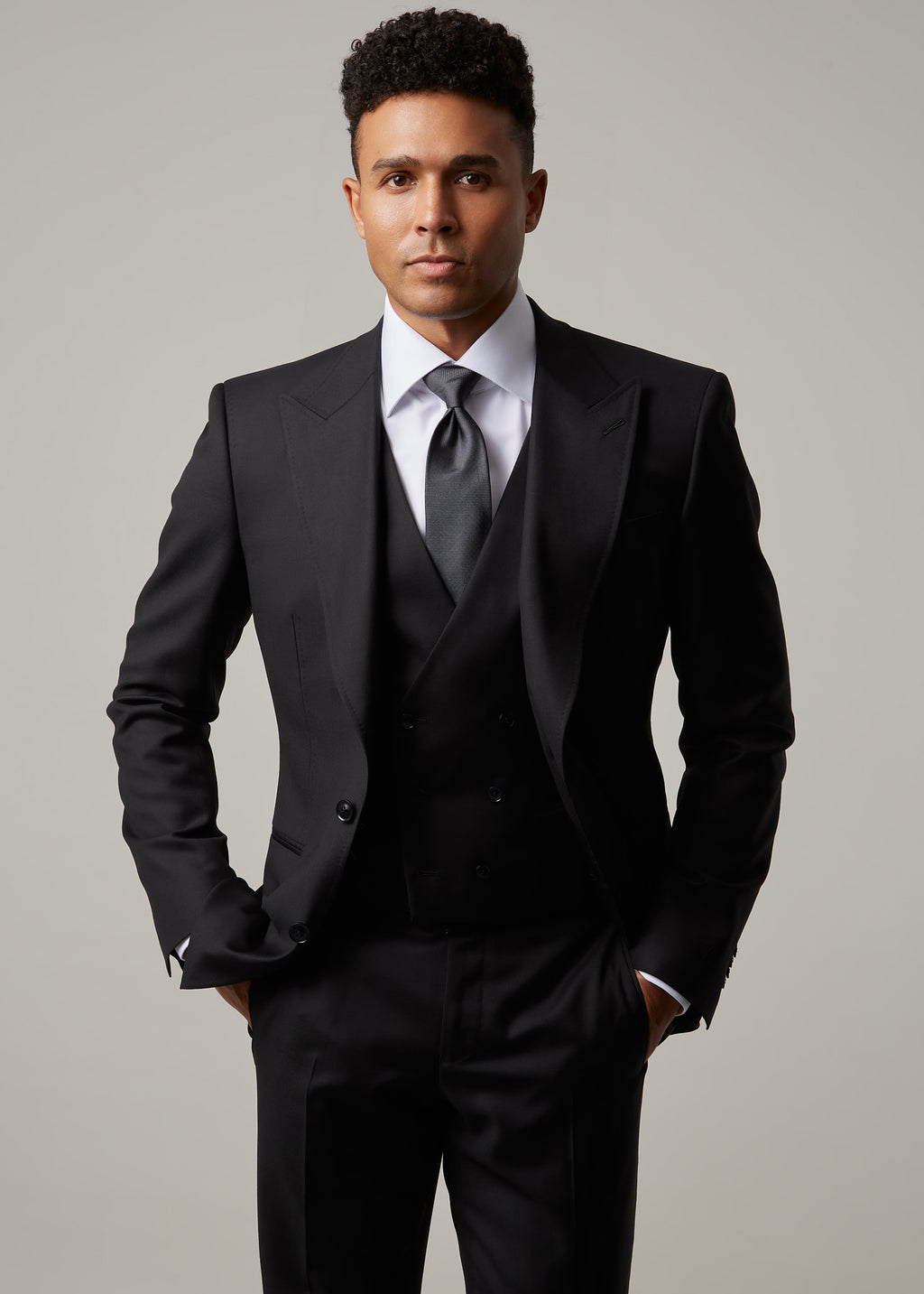 Midnight Milano The Ultimate Black Suit worn with a waistcoat, close crop with hand at the hip