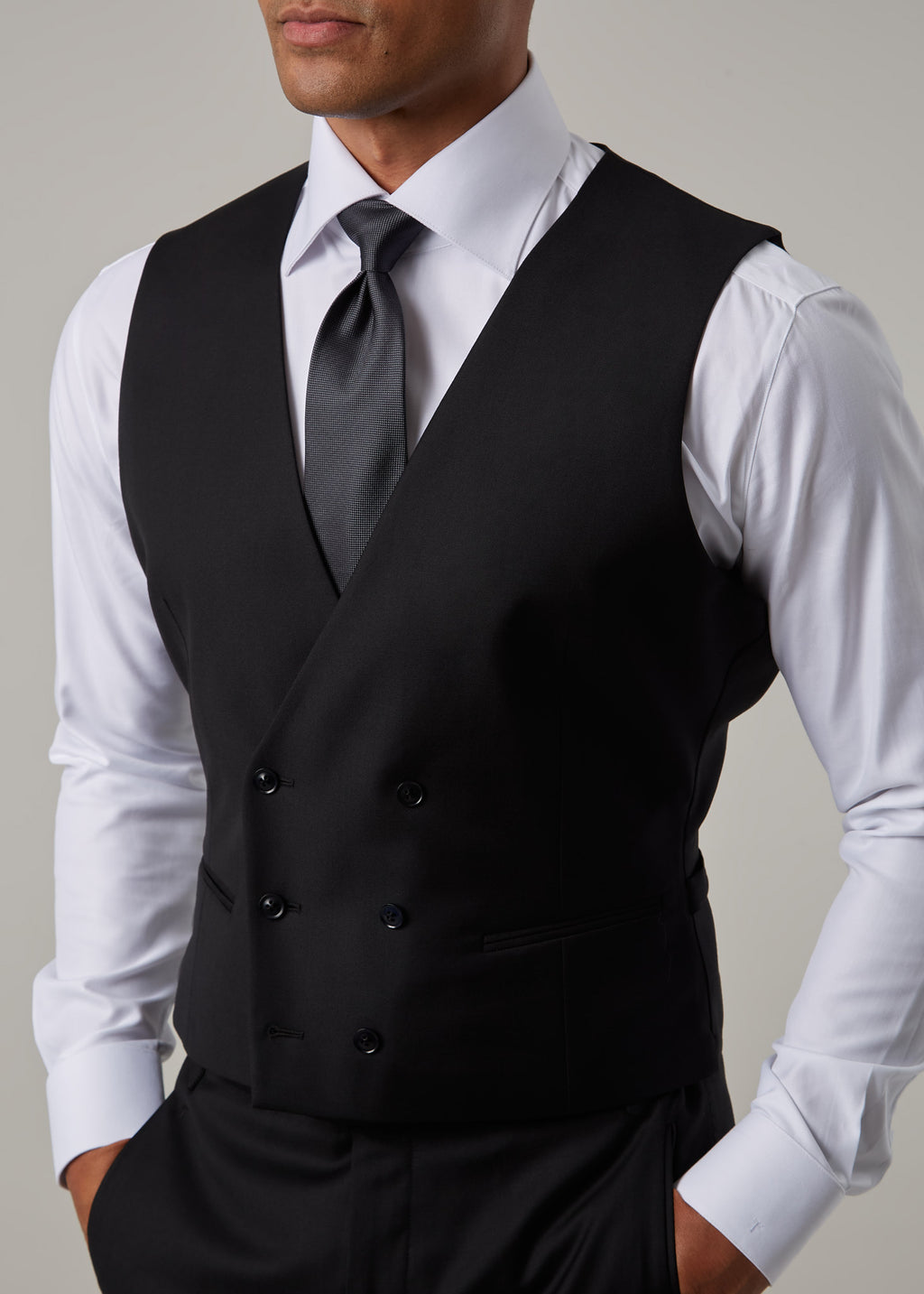 Midnight Milano The Ultimate Black Suit waistcoat, closer crop with a hand in the pocket