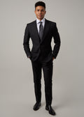 Midnight Milano The Ultimate Black Suit worn full-length on a model, hands in pockets