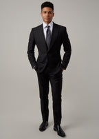 Midnight Milano The Ultimate Black Suit worn full-length on a model, hands in pockets