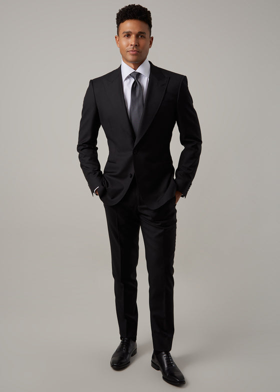 Midnight Milano The Ultimate Black Suit worn full-length on a model, hands in pockets