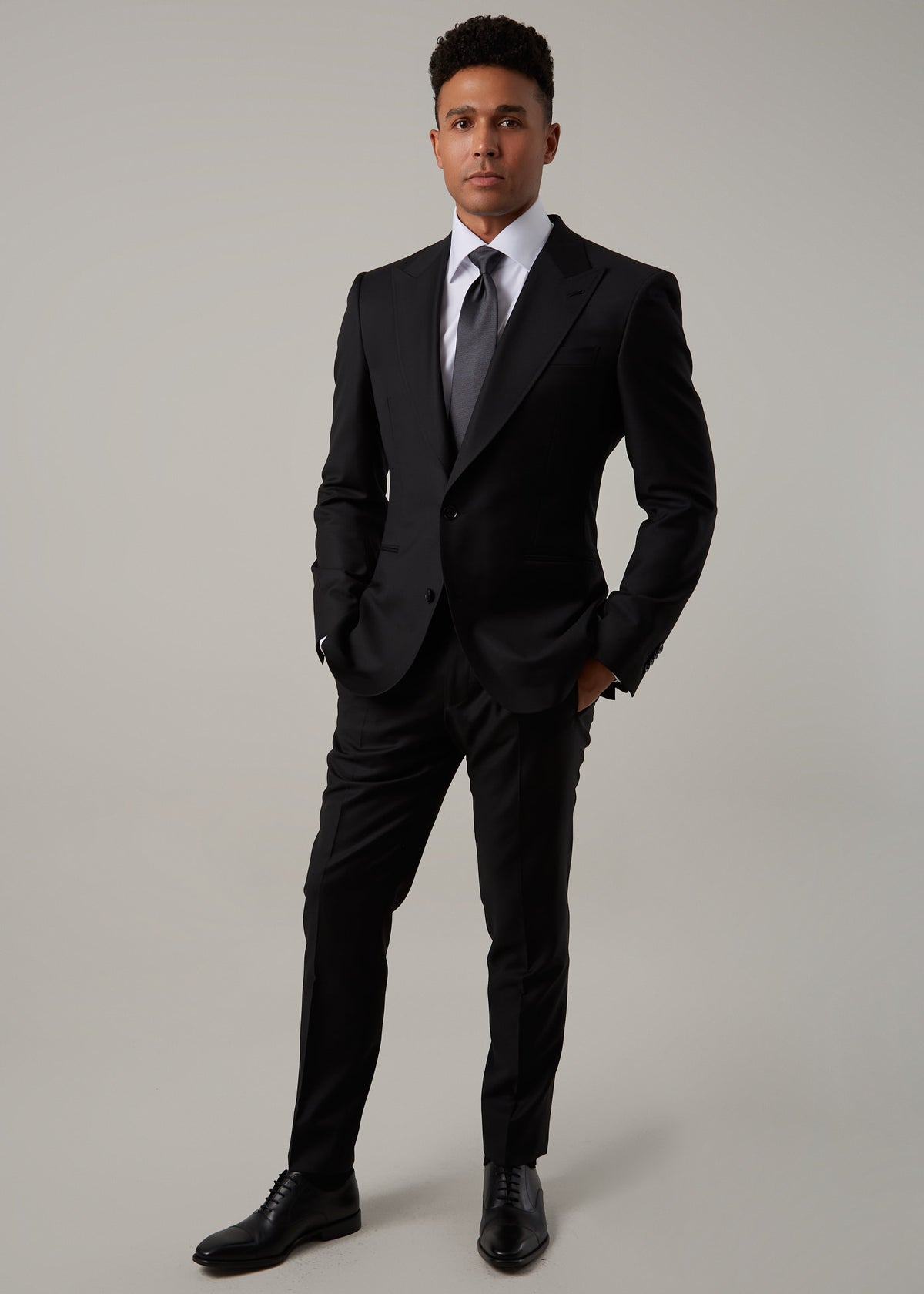 Midnight Milano The Ultimate Black Suit worn full-length, standing square to the camera