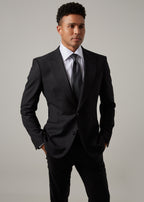 Midnight Milano The Ultimate Black Suit worn full-length, head turned to the side