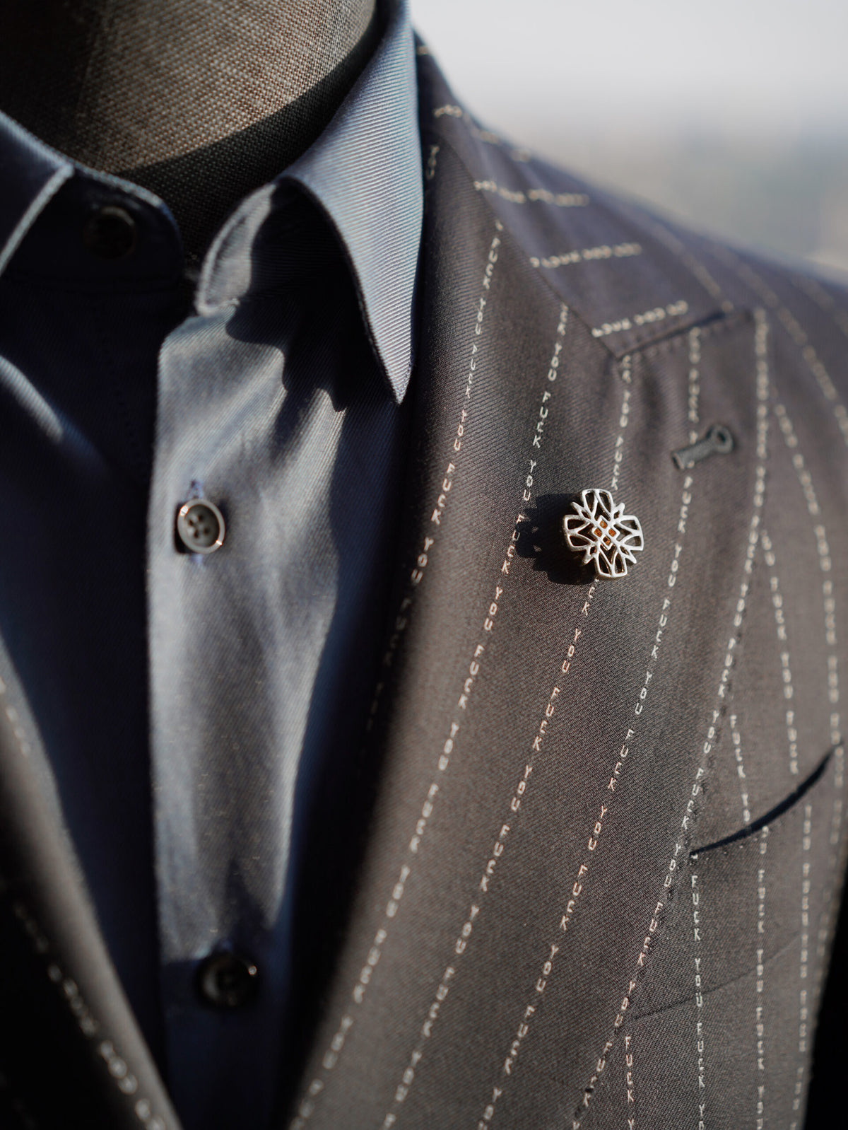 The No Filter Navy Pinstripe Suit, close-up of the lapel pin and pinstripe fabric