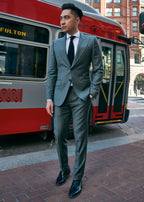 Ginza Greenway Suit worn by a model standing beside a red tram, three-quarter view