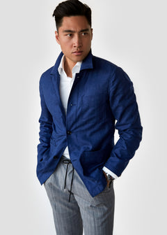 Blue Shirt Jacket worn open by a model over striped drawstring trousers
