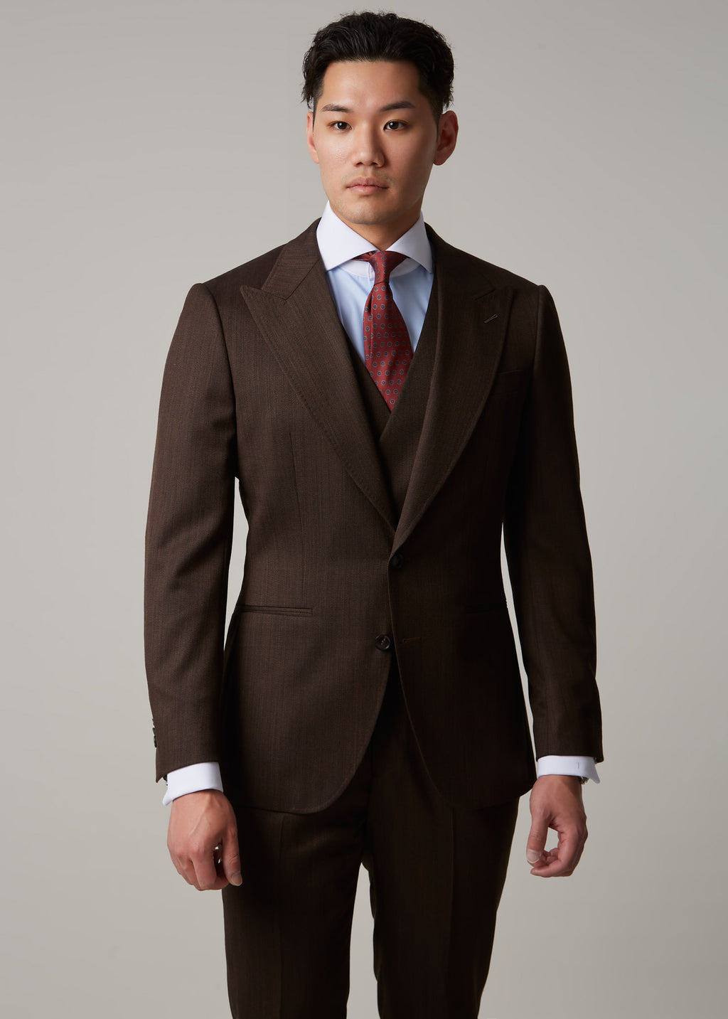 Lexington Brown Suit, close front crop on a model with a direct gaze