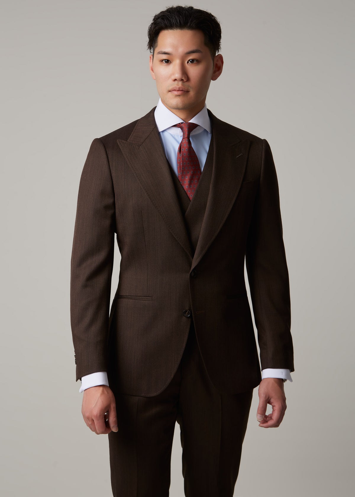 Lexington Brown Suit, close front crop on a model with a direct gaze