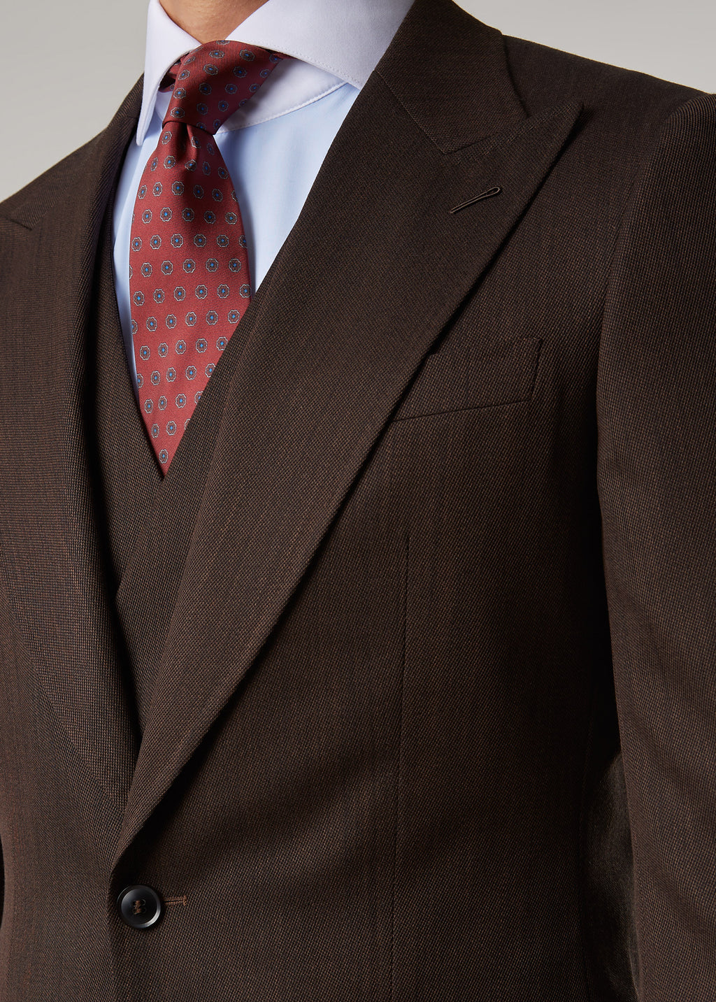 Lexington Brown Suit, cropped close-up of the buttoned jacket front and pockets