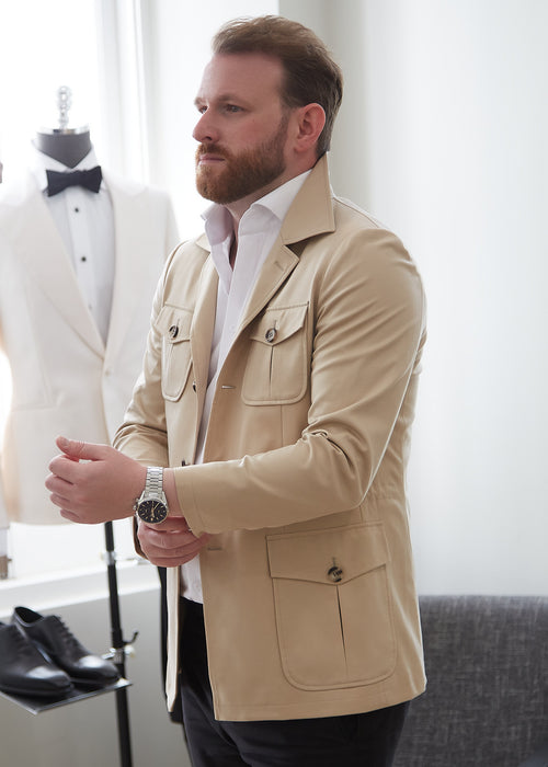 Cream Safari Jacket, angled view showing the patch pockets in a showroom setting