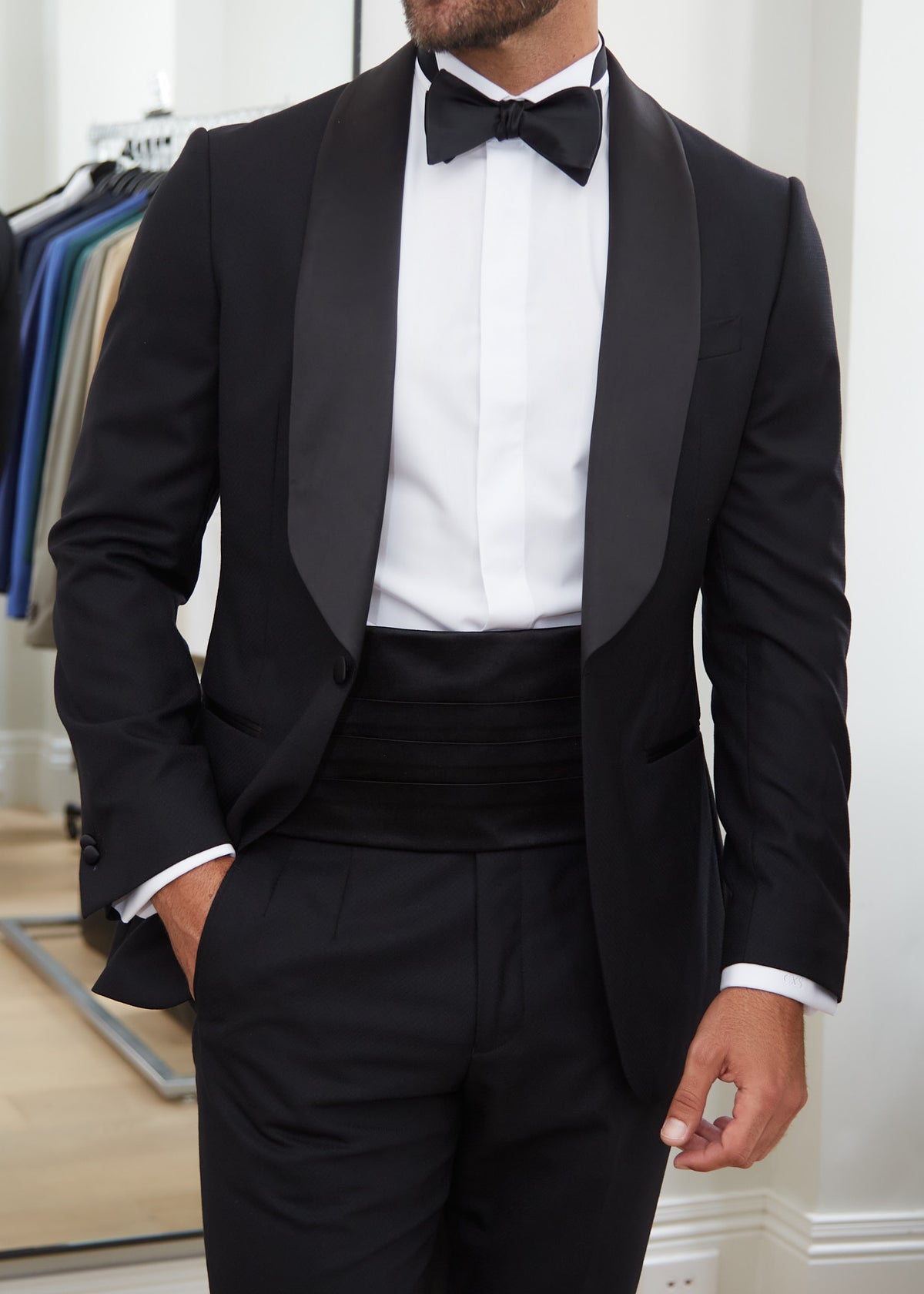 Black Silk Tuxedo Cummerbund worn with a bow tie and shawl-lapel jacket, close crop
