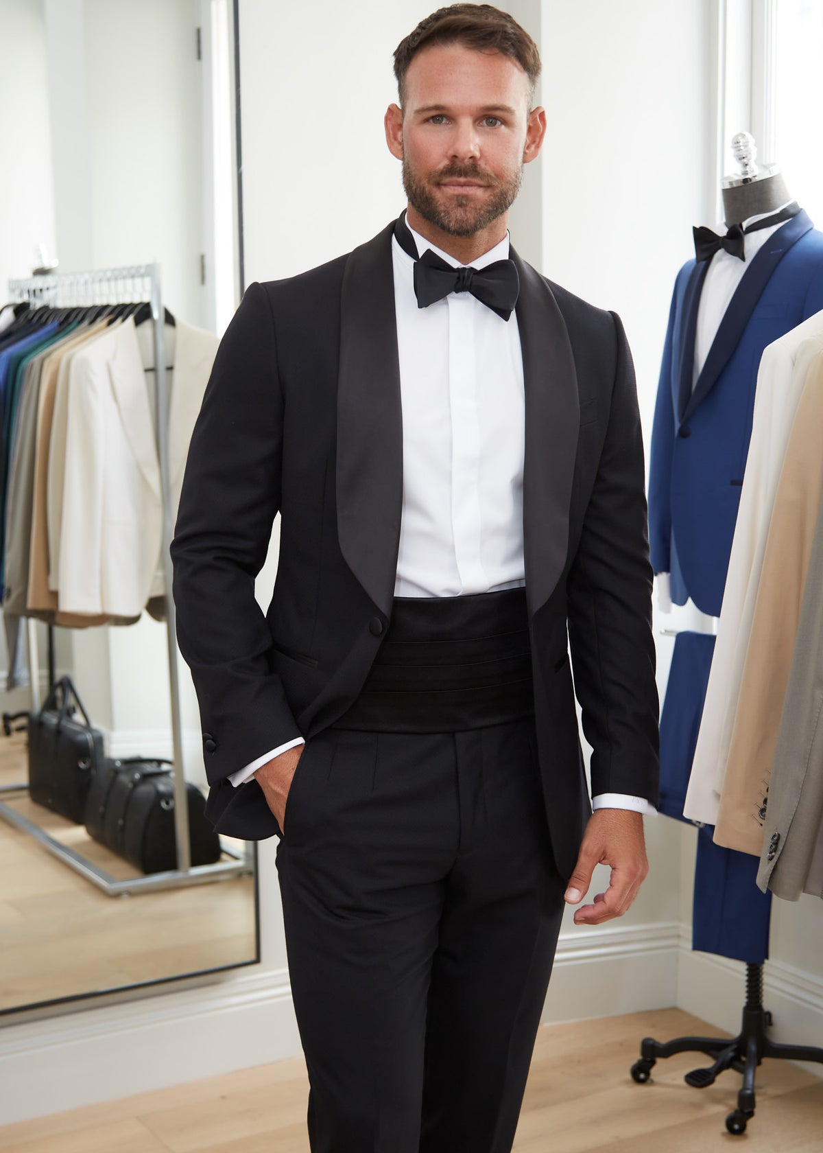Black Silk Tuxedo Cummerbund worn with a tuxedo, wider view in a showroom setting