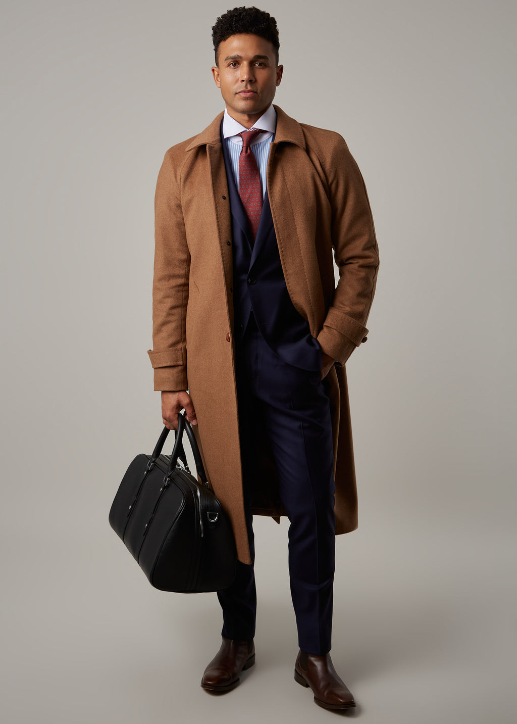 Toasty Truffle Cashmere Blend Overcoat worn open, three-quarter view holding a black bag
