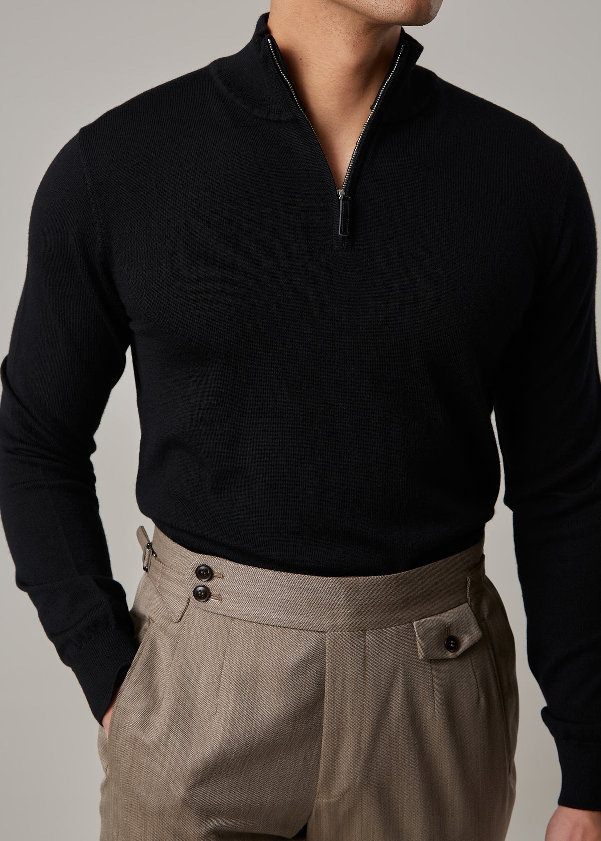Cosmo quarter-zip jumper in black, worn on a model with the zip half-open
