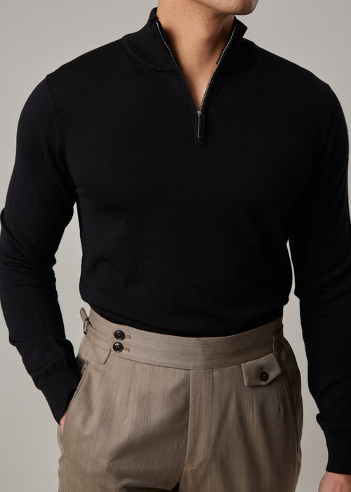 Cosmo quarter-zip jumper in black, worn on a model with the zip half-open