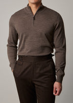 Cosmo quarter-zip jumper in brown, worn on a model with hand in pocket