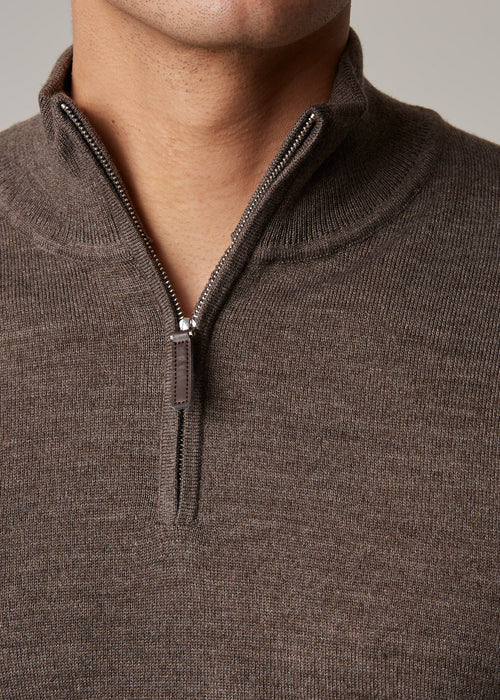 Close-up of the brown Cosmo quarter-zip jumper's collar and zip pull