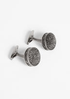 Gunmetal Token Cufflinks shown at an angle with the toggle bars visible