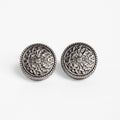 Gunmetal Token Cufflinks, front-on flat lay of the engraved medallion faces
