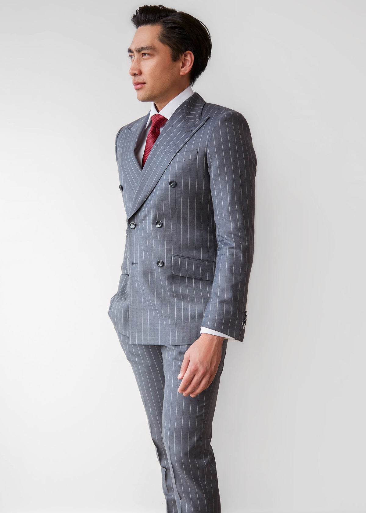 Wall Street Charcoal Pinstripe Suit styled with a red tie, angled side view