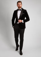 Artillery Black Velvet Tuxedo, standing shot of a model fastening the jacket button