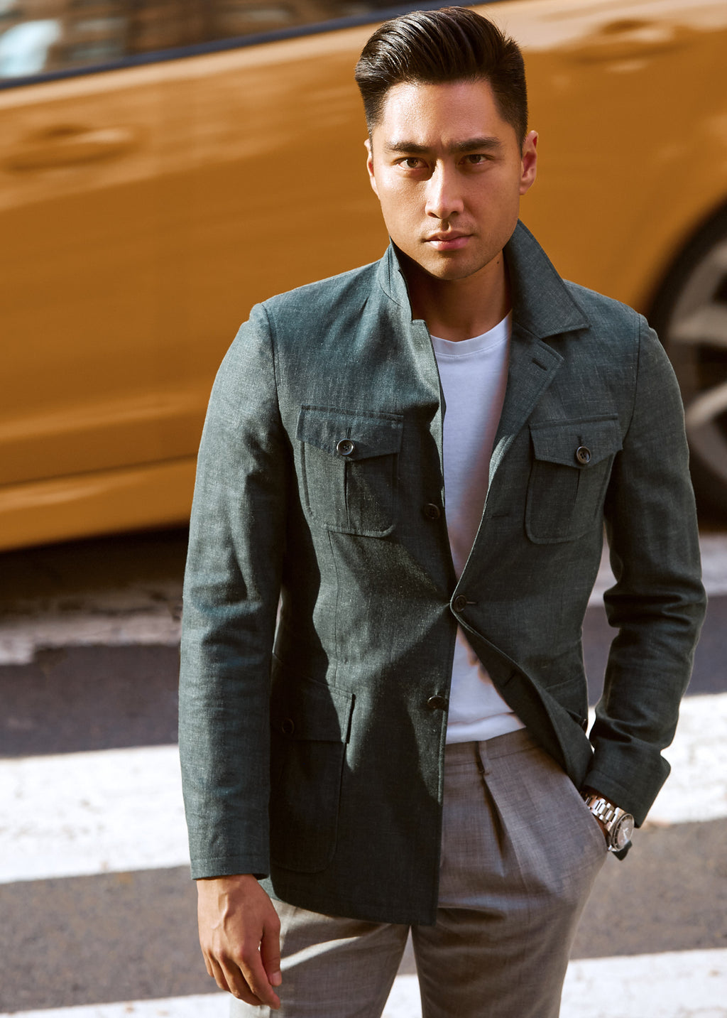 Green Safari Jacket worn over a white T-shirt by a model on a city street