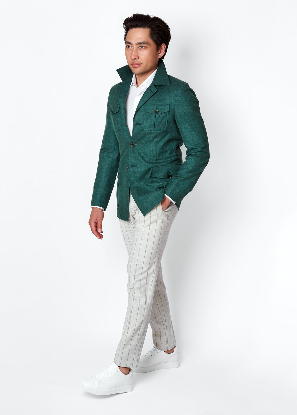 Green Safari Jacket, side profile styled with white striped trousers and sneakers