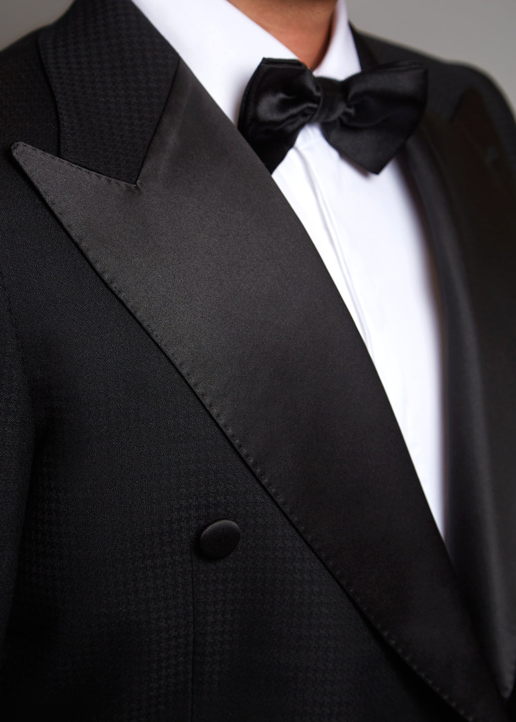 The Monte Carlo Black Tuxedo, close-up of the satin peak lapel and bow tie