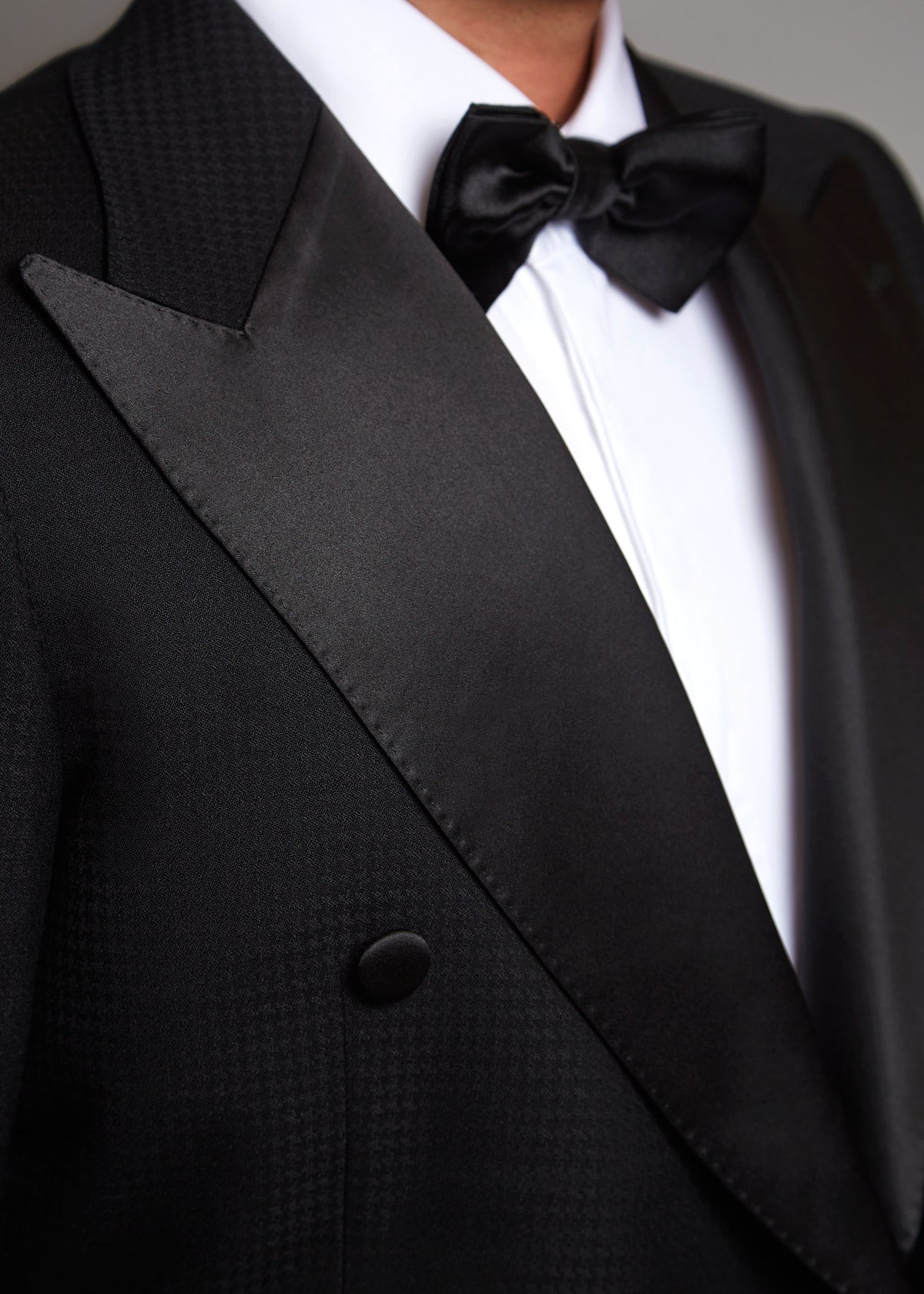 The Monte Carlo Black Tuxedo, close-up of the satin peak lapel and bow tie