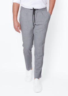 Grey Pinstripe Drawstring Pants worn with a white polo and trainers, front view