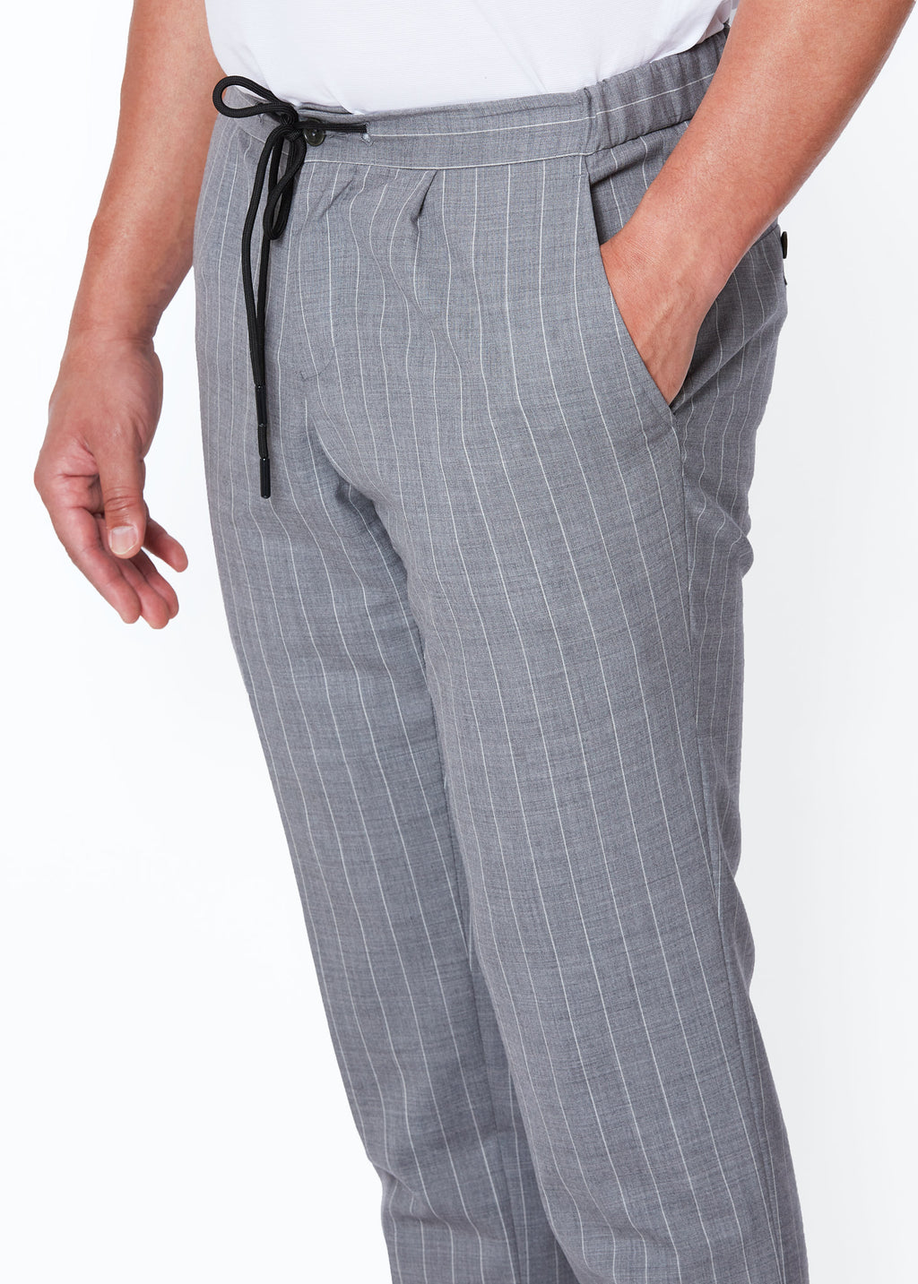 Close-up of the Grey Pinstripe Drawstring Pants waistband, hand in pocket