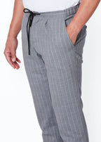 Close-up of the Grey Pinstripe Drawstring Pants waistband, hand in pocket