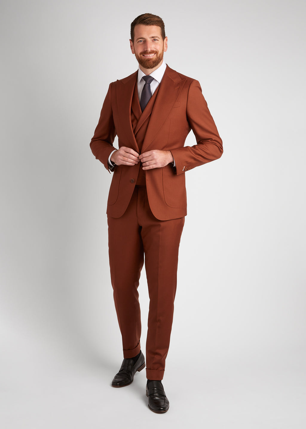 Birmingham Tobacco Brown Suit with waistcoat and tie, adjusting the sleeve cuff