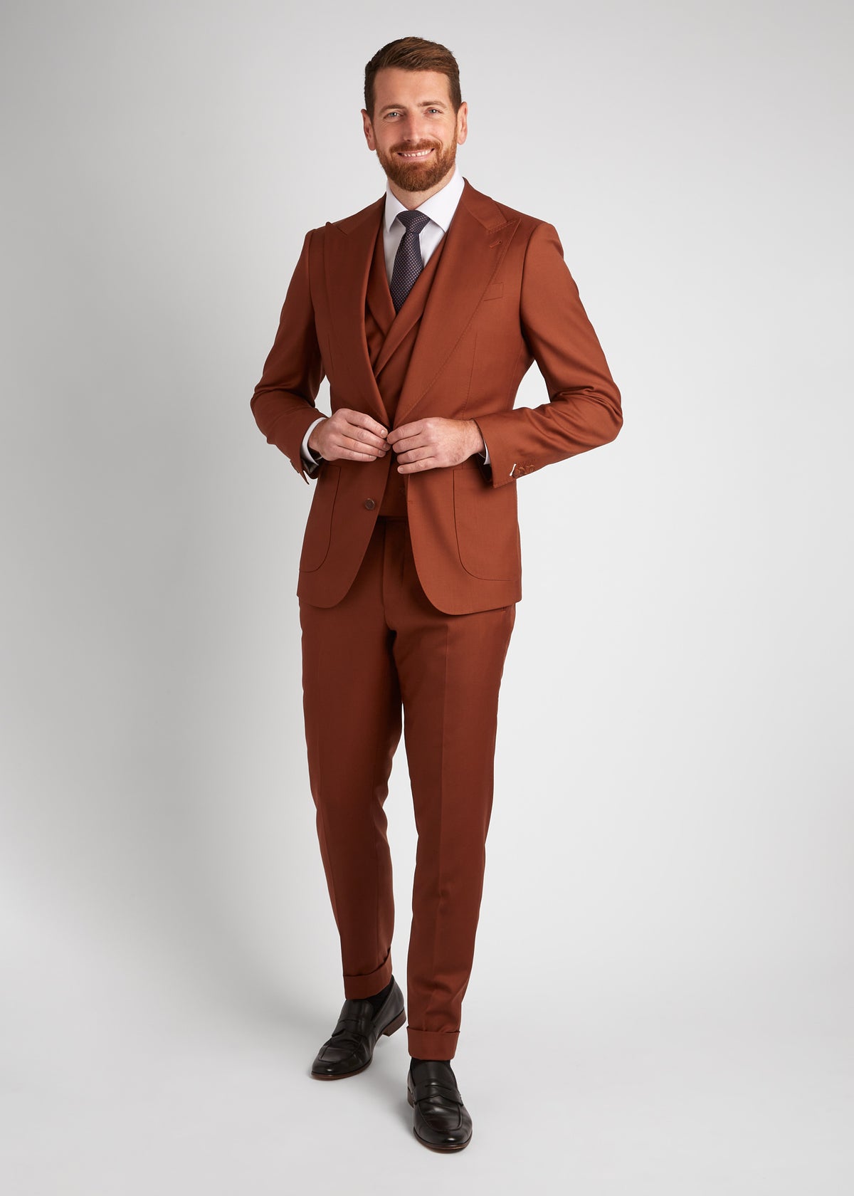 Birmingham Tobacco Brown Suit with waistcoat and tie, adjusting the sleeve cuff
