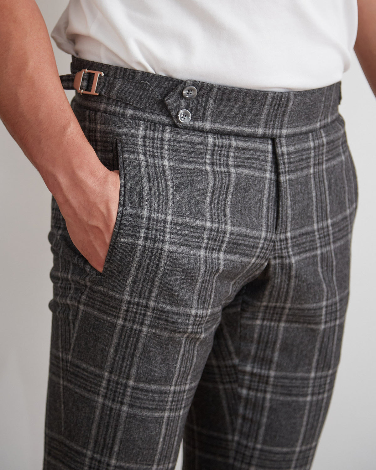 Abbey Road Charcoal Check Suit trousers, close-up of the button waistband tab, hand in pocket