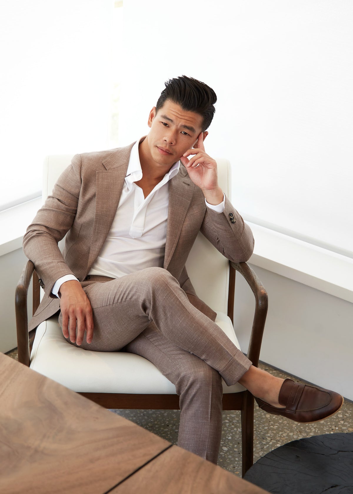 Park Avenue Sand Brown Linen Blend Suit worn by a model seated in a chair, open collar